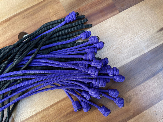 Weighted purple and black paracord flogger falls for BDSM and impact play