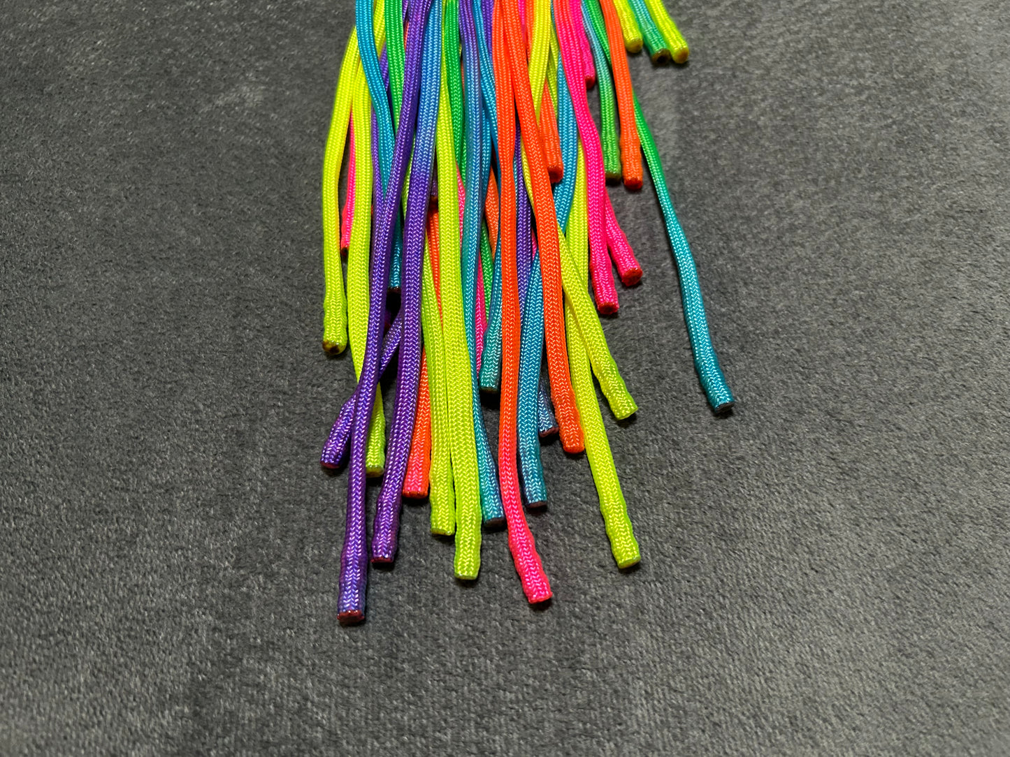 Rainbow weighted paracord flogger with pink buttplug handle