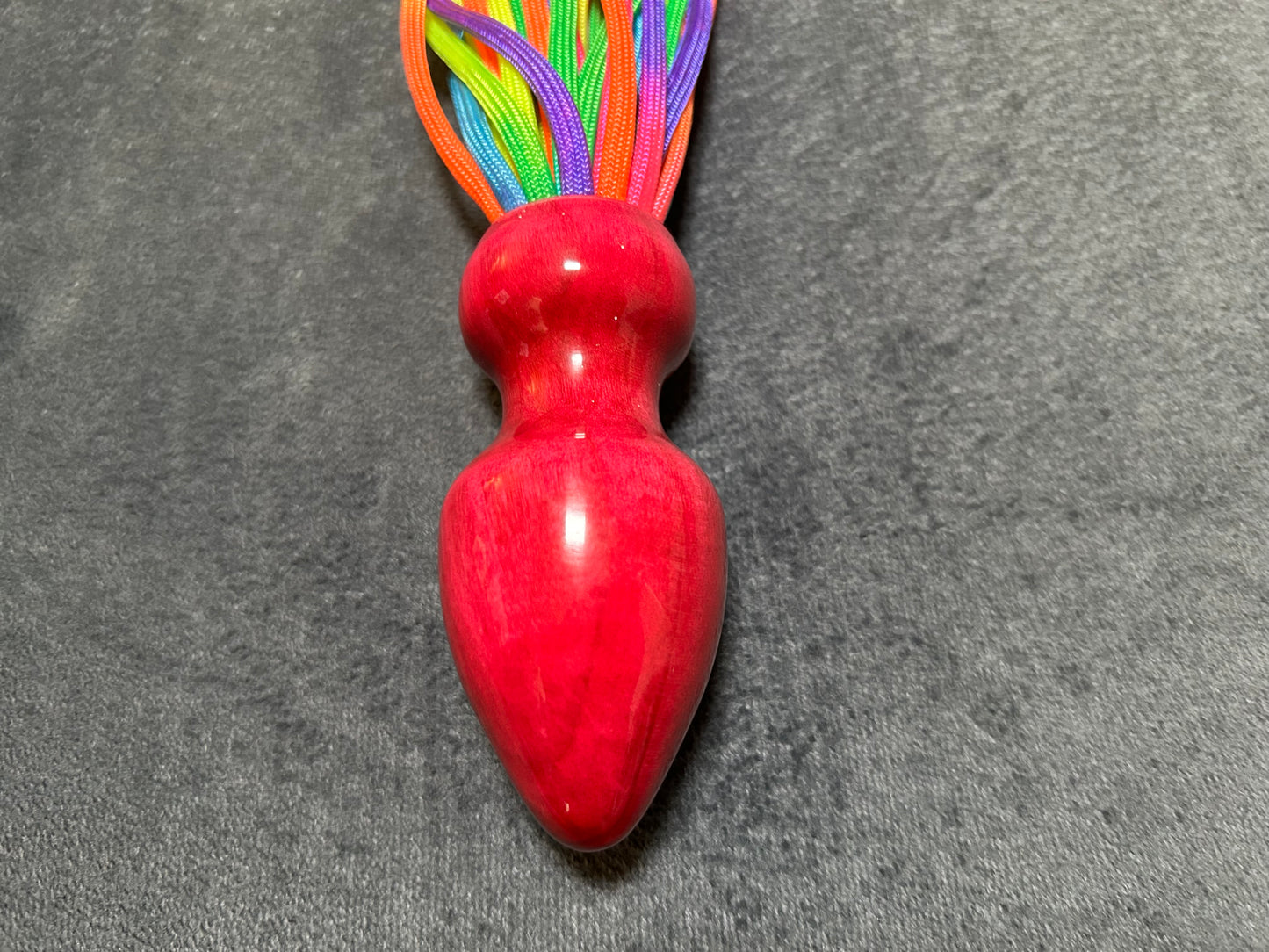 Rainbow weighted paracord flogger with pink buttplug handle
