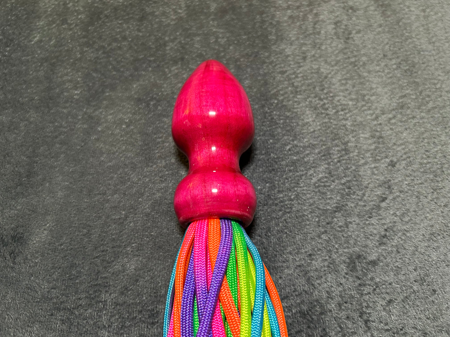 Rainbow weighted paracord flogger with pink buttplug handle