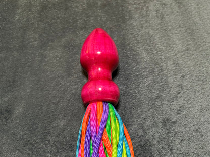 Rainbow weighted paracord flogger with pink buttplug handle