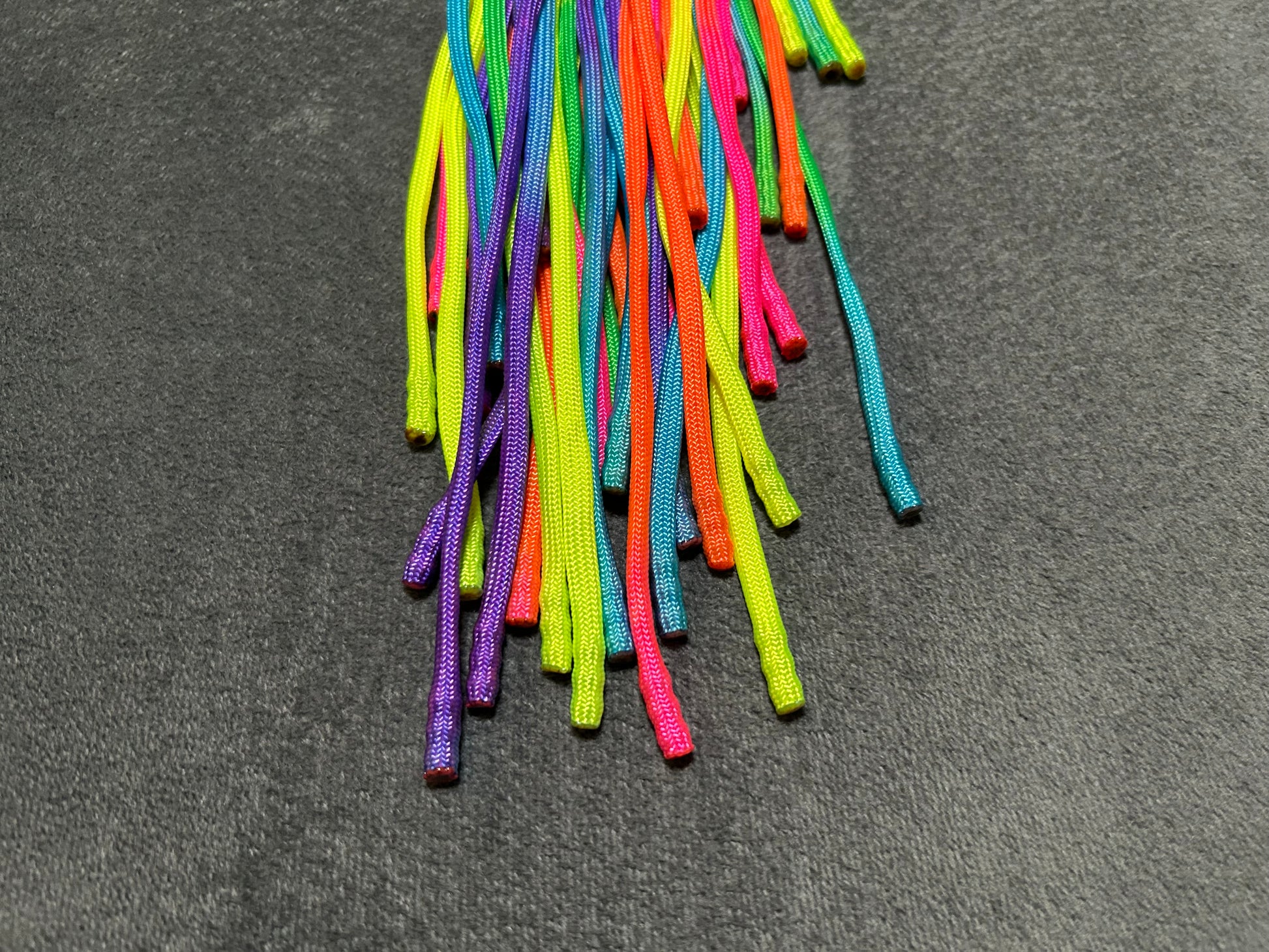 Rainbow weighted paracord flogger with pink buttplug handle